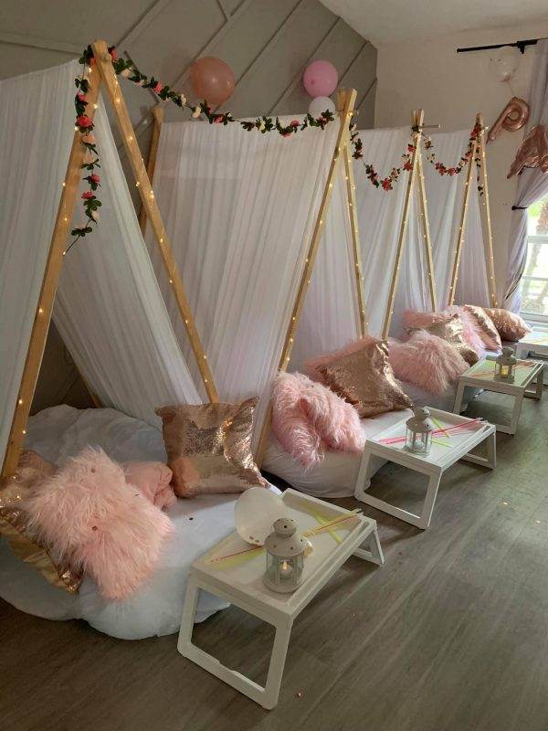Glam slumber party theme with teepees, food trays, pillows and mattresses