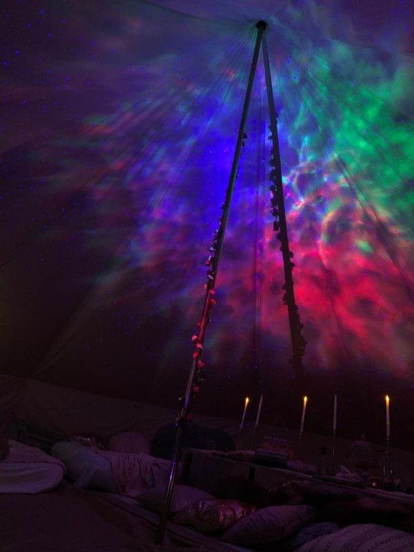 A colorful Bell Tent with starry lights and a starry sky.
