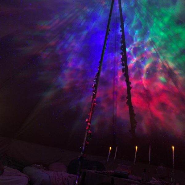 A colorful Bell Tent with starry lights and a starry sky.