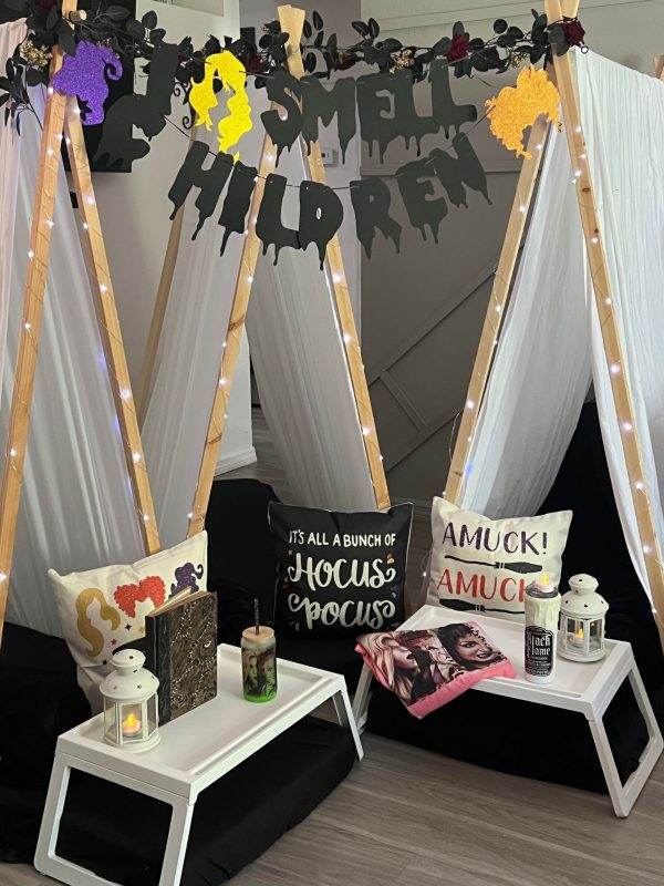 A room transformed into a spooky Halloween party with teepees and eerie decorations.
