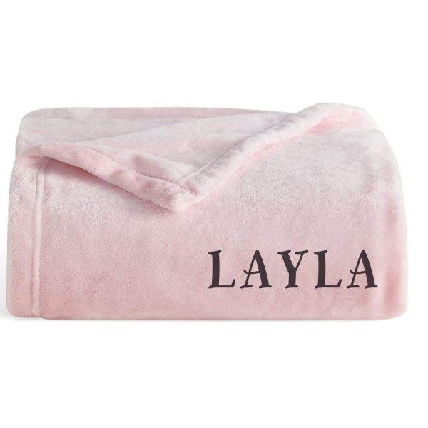 A pink blanket with the word layla on it, perfect for glamping.