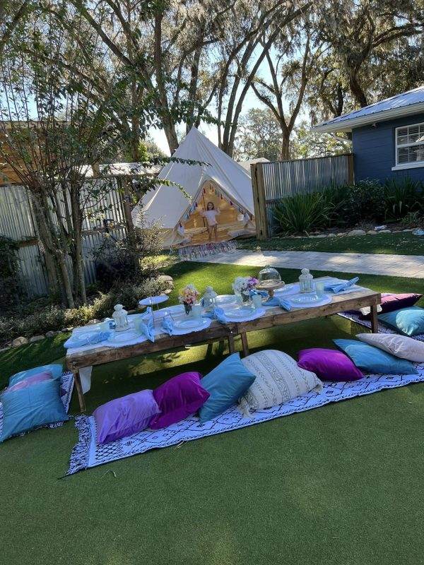 Boho Luxury picnic theme with large glamping tent in the background.
