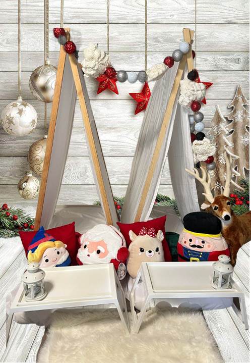 Christmas themed teepee tents with Santa and elf pillows.