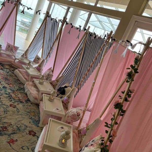 Pink teepee tents for a girl's birthday party featuring Slime decorations.