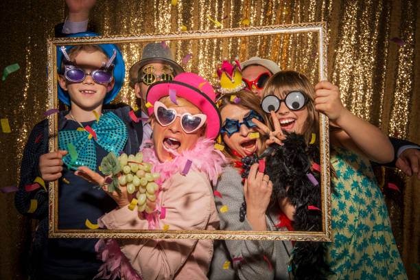 A group of people posing for a photo in a party photo booth.