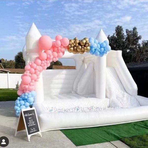 An inflatable 15FT X 13FT White Bounce House adorned with colorful balloons and a festive sign, perfect for creating fun and excitement at a Lakeland party.