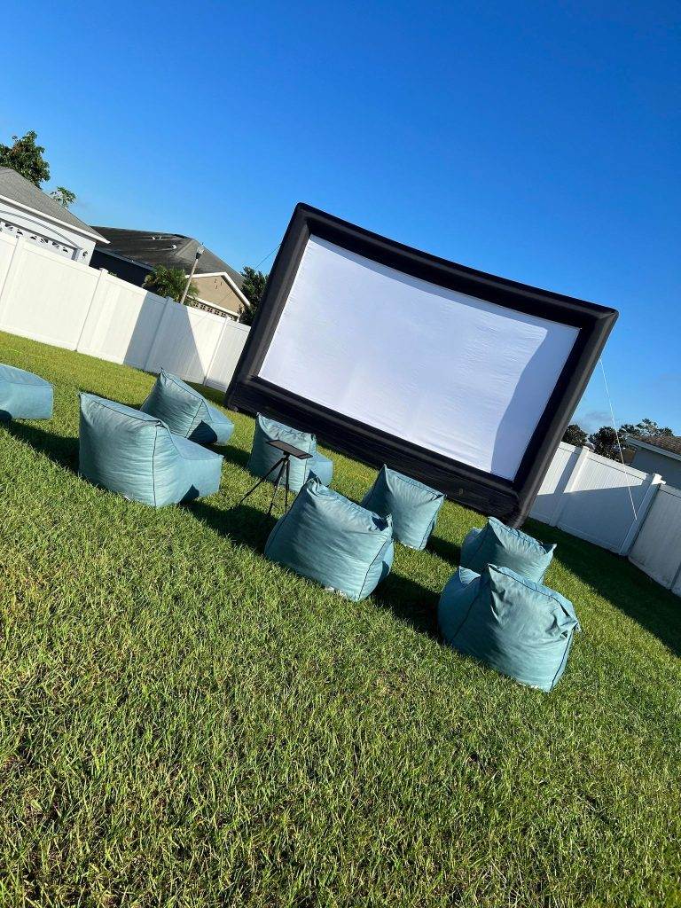 Outdoor Movie with a 30 foot inflatable projection screen, lounge chair seating in front of the movie screen.