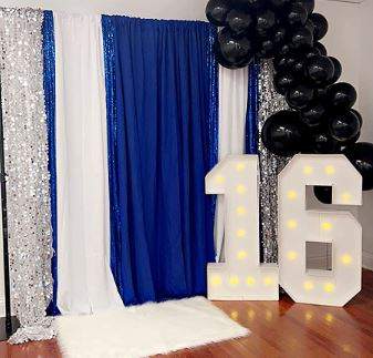 A blue and white backdrop with balloons for a 16th birthday party, along with the rental of 4FT Marquee Light Up Letters.