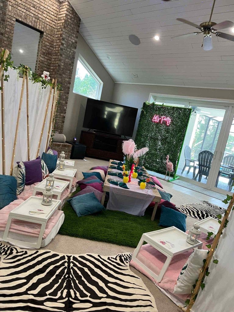 A living room with a zebra print rug and a Teepee.