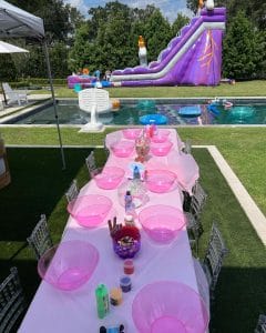 A **teepee** set up with pink plates and a water slide.