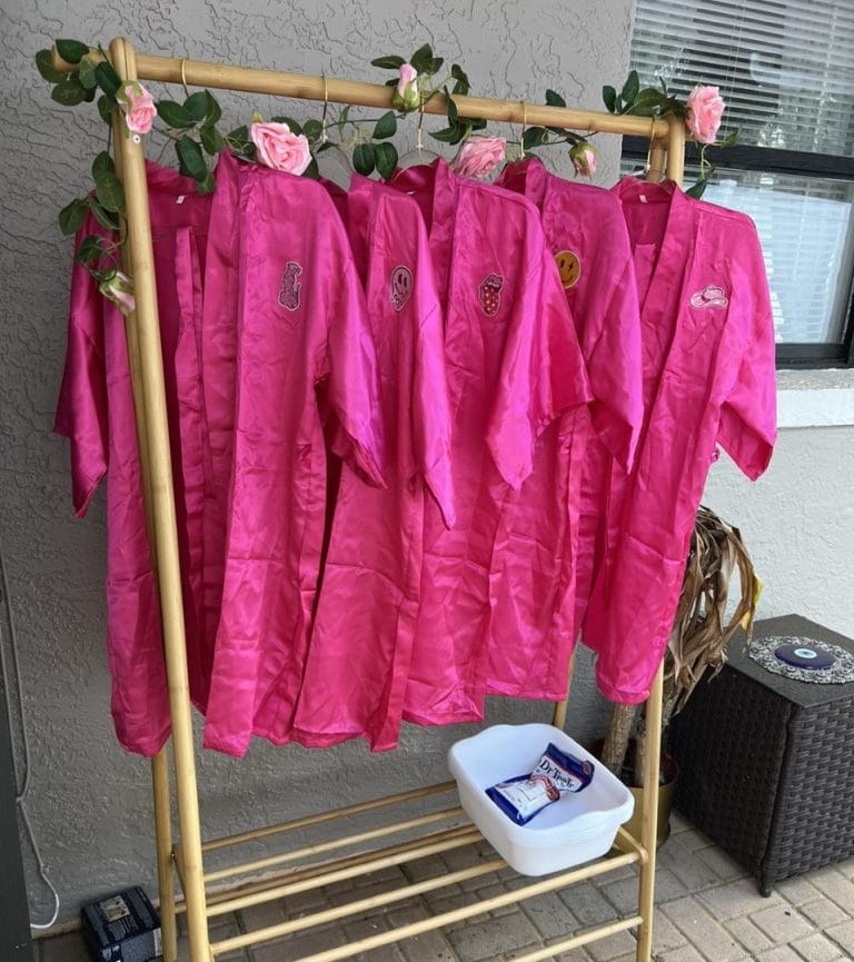 Pink robes hanging on a Teepee rack.