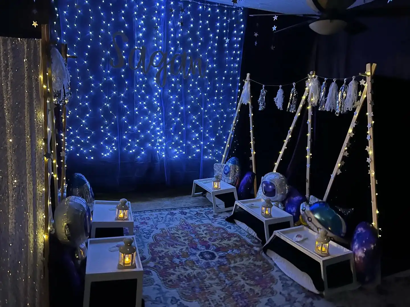 A party room adorned with blue lights and candles for a glamping experience.